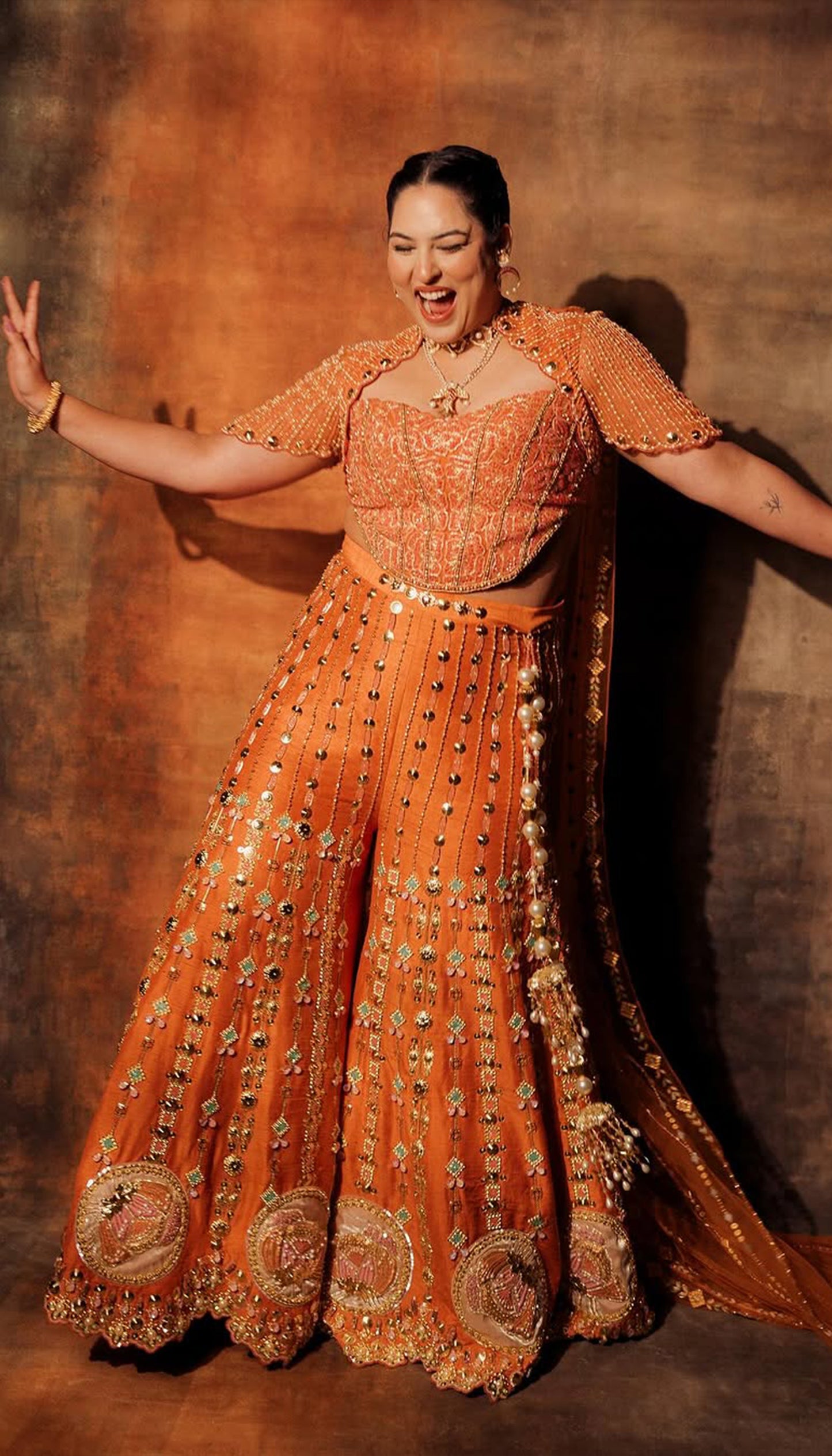 SAKSHI IN CEO OF ART - ORANGE SHARARA SET